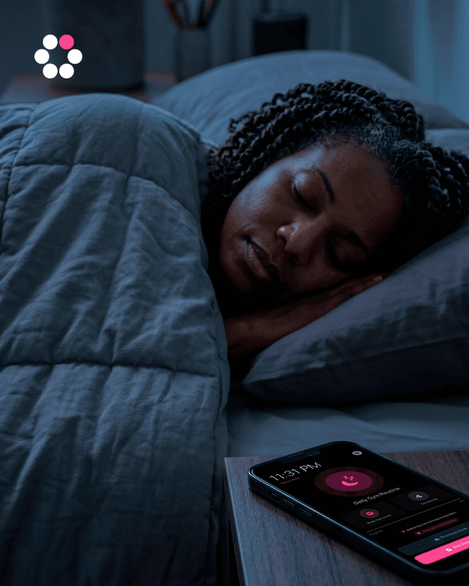 Person asleep, phone on nightstand with screen dimmed